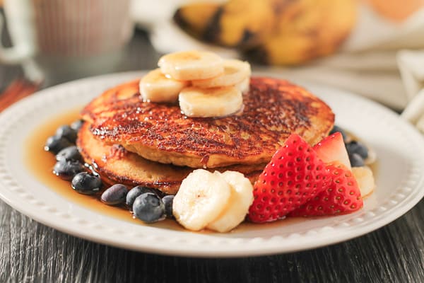 These Banana Coconut Flour Pancakes are the perfect option for your weekend breakfast. This gluten free and dairy free recipe is super filling and tastes lovely with fresh fruit and maple syrup. #healthy #glutenfree #pancakes