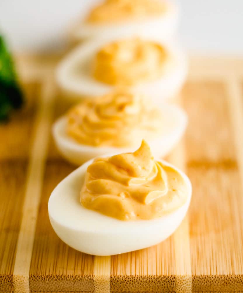 a board of hummus deviled eggs.