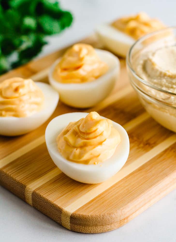 a tray of hummus deviled eggs.