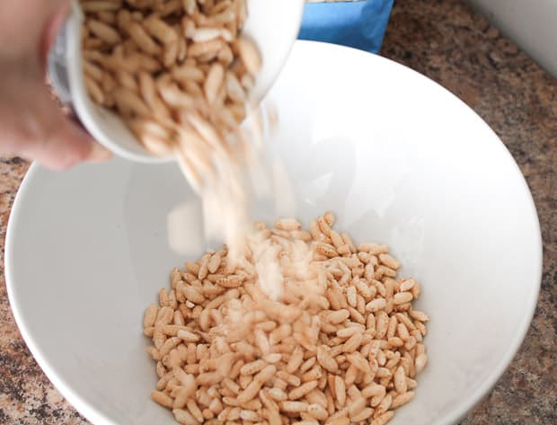 brown rice crispies cereal being poured into a bowl