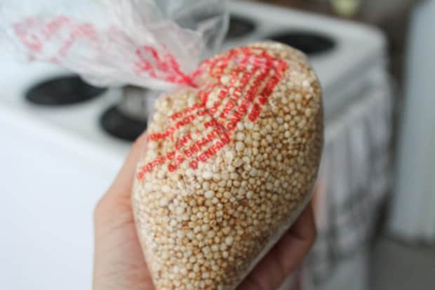 hand holding a baggie of puffed quinoa