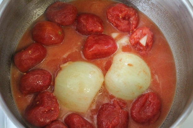 Rich tomato sauce stewing in a large saucepan