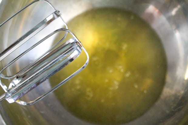 a large mixing bowl with 10 egg whites about to be beaten with a hand mixer