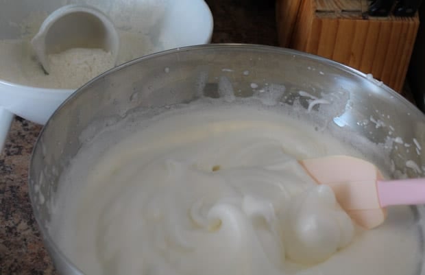 egg whites being gently folded into the cake batter