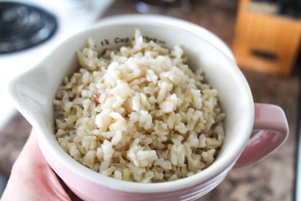 Cooked brown rice in a measuring cup