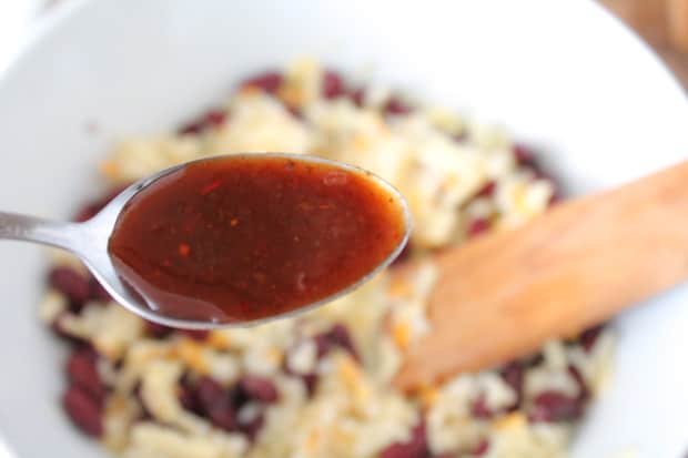 Spoonful of adobo sauce in front of a mixing bowl.