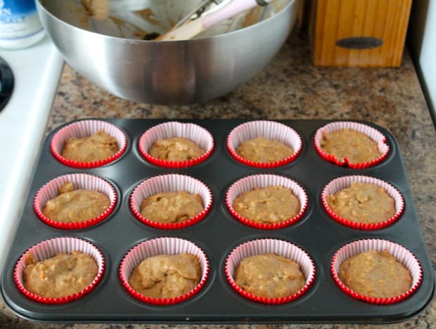 Muffin tin with Carrot Date Muffin batter in cupcake liners