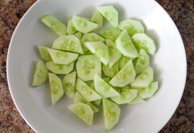 mixing bowl with sliced cucumbers