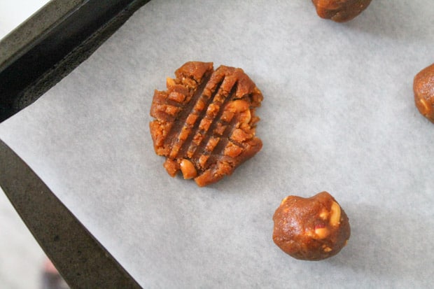 peanut butter cookie with a crisscross pattern on it ready for the oven