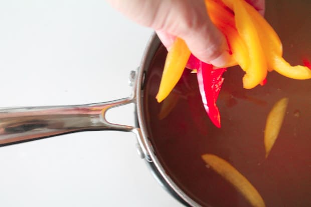 Peppers being dropped into a soup pot