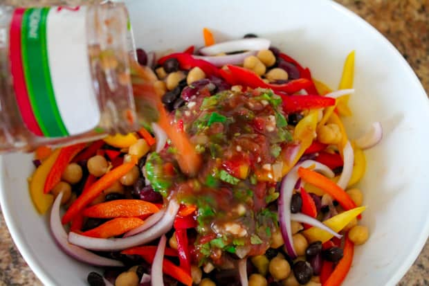 dressing being poured on ingredients.