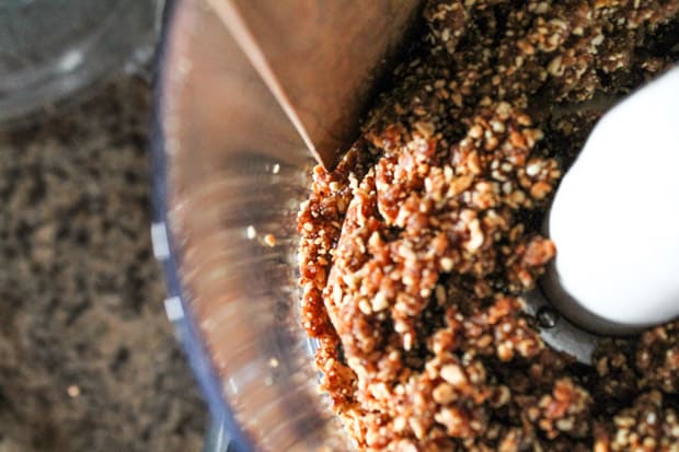 Dates, almonds and bananas being processed in a food processor