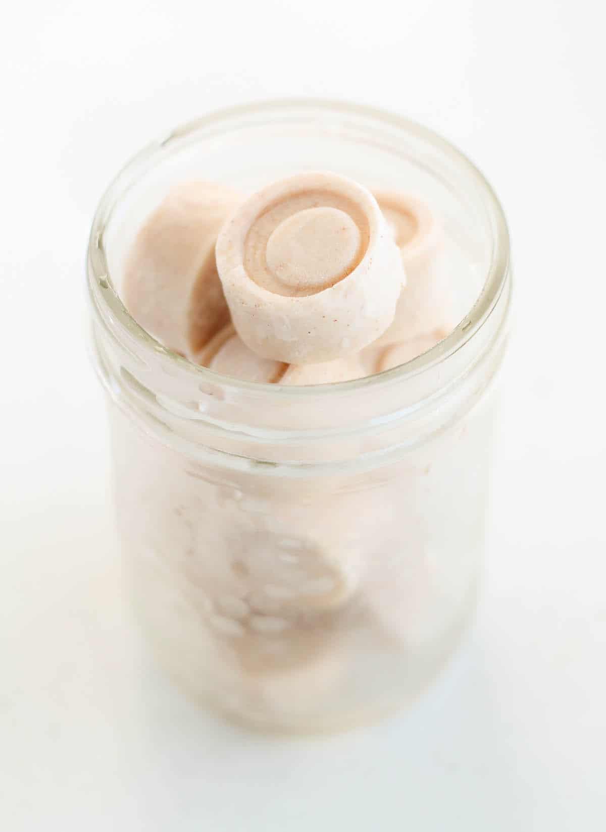 frozen yogurt bites in a frosty glass jar