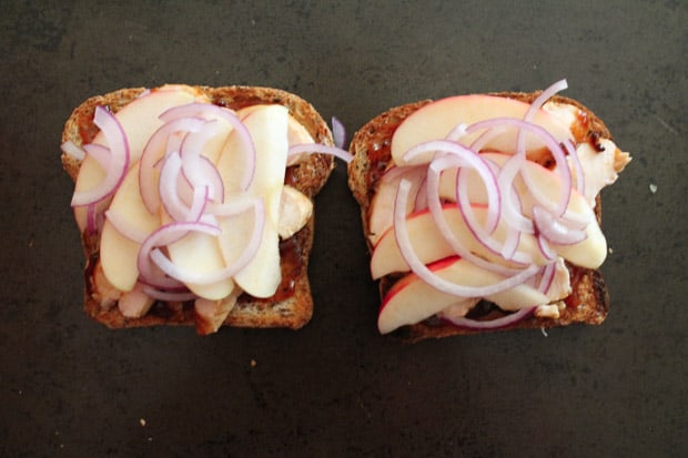 thinly sliced apples and onions layered on the toast