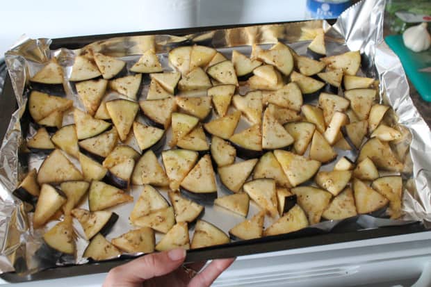 Sliced eggplant on a baking sheet ready for the oven