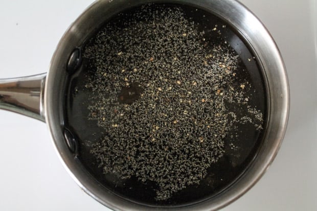 a small saucepan with a dark liquid mixture inside