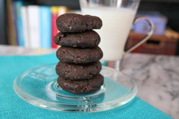 Vegan Banana Brownie Cookies on a plate with a glass of milk in the background