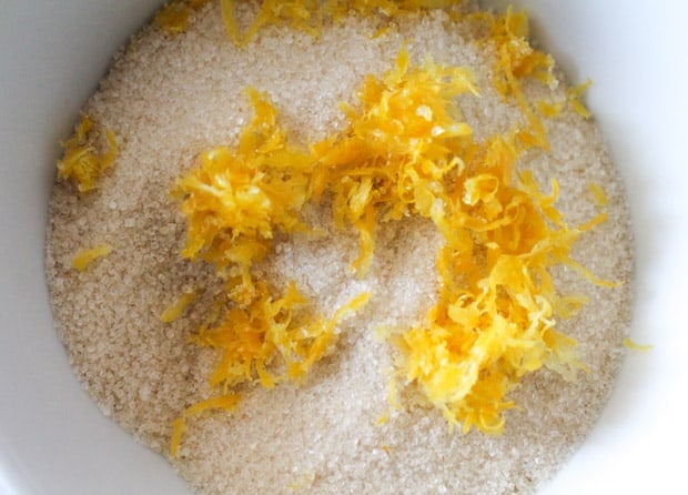 muffin ingredients and lemon zest in a white mixing bowl
