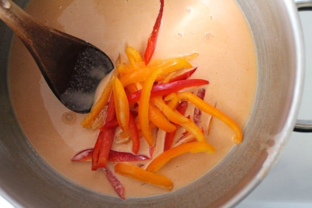 crisp peppers being added to a soup pot