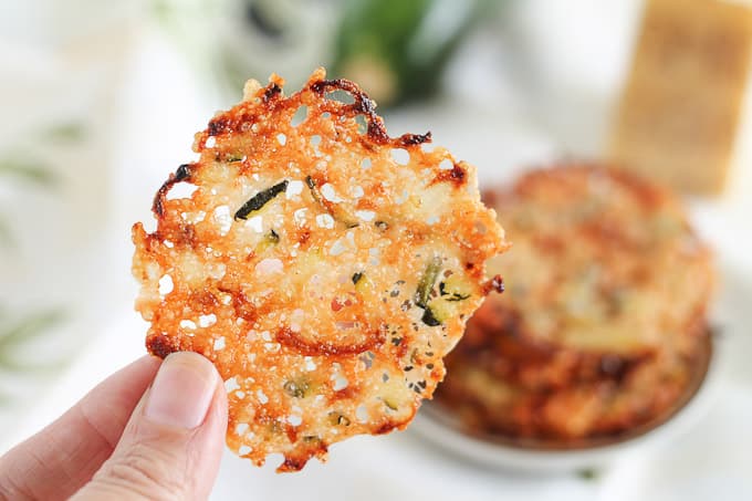 hand holding parmesan zucchini chips