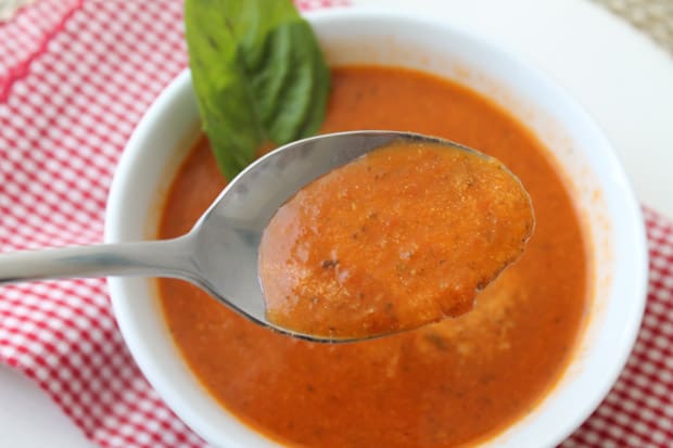 a spoon with roasted tomato soup 