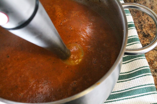 soup being pureed by an immersion blender