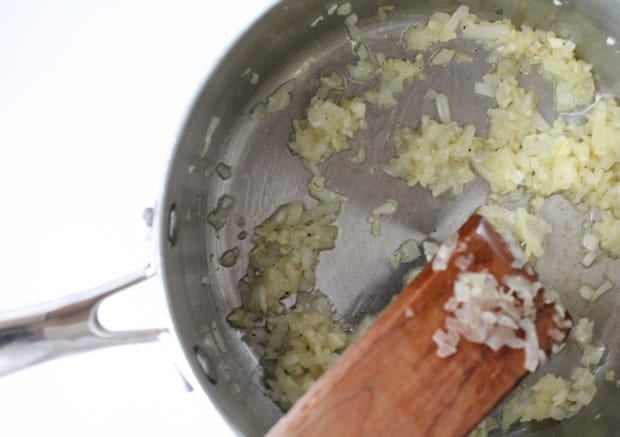 garlic being sauteed in a saucepan