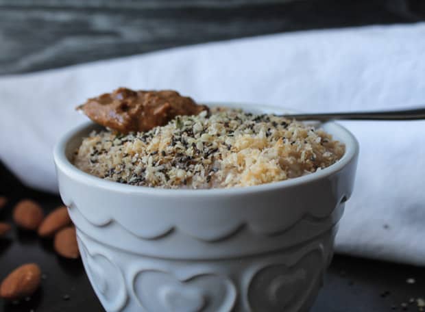 Oat Bran Breakfast Bowl with a spoon full of almond butter on top