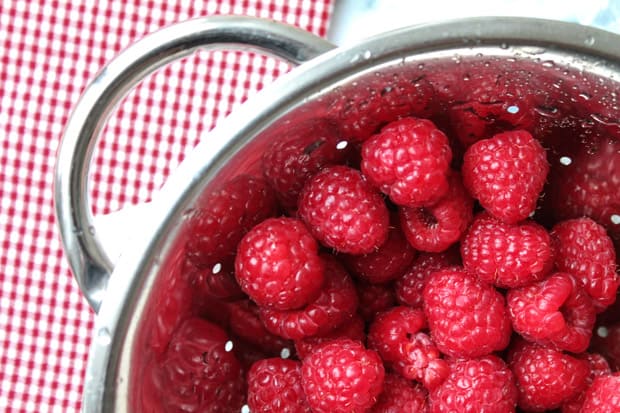 Recently rinsed raspberries in a colander