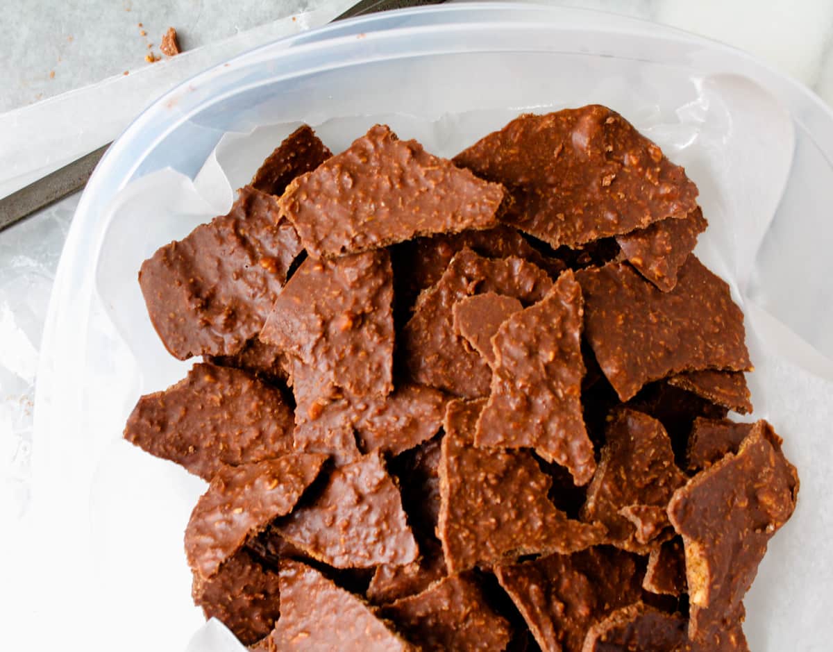 a container full of pieces of healthy chocolate bark.