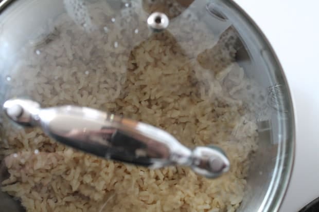 Brown rice cooking in a saucepan