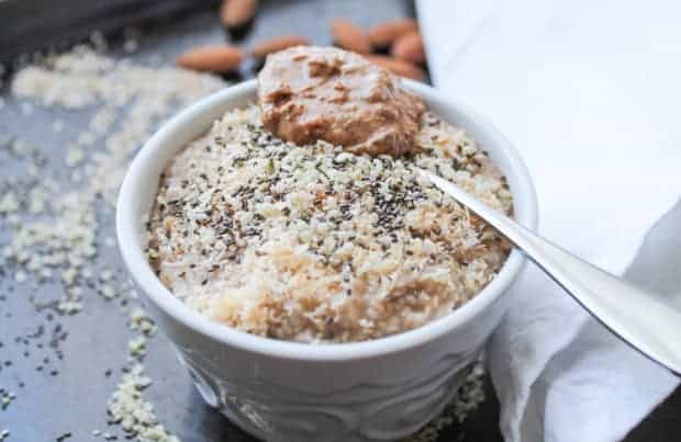 Oat Bran Breakfast Bowl with a spoon full of almond butter on top