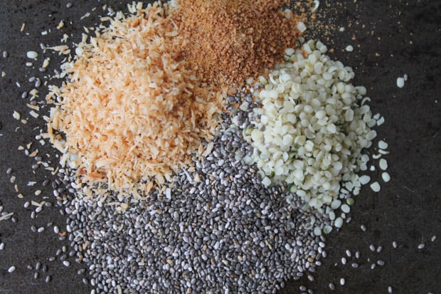 chia seeds, hemp seeds, coconut sugar, toasted coconut on a baking tray 