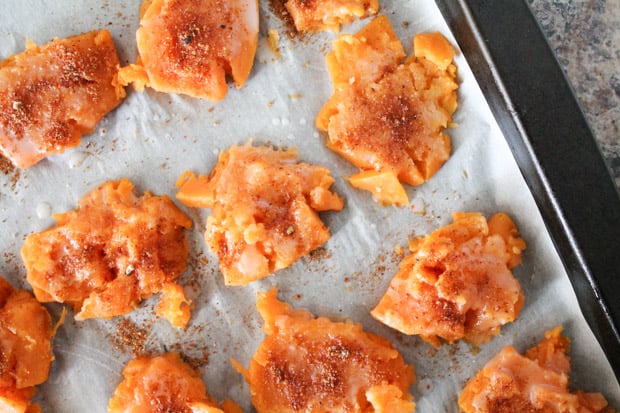 Seasoned sweet potatoes on a baking sheet