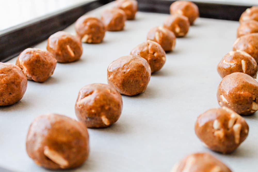 almond butter balls on a baking tray.