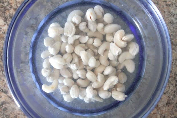 Cashews soaking in a glass bowl