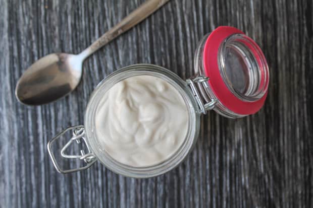 Dairy Free Sour Cream in a jar with a spoon laying next to it
