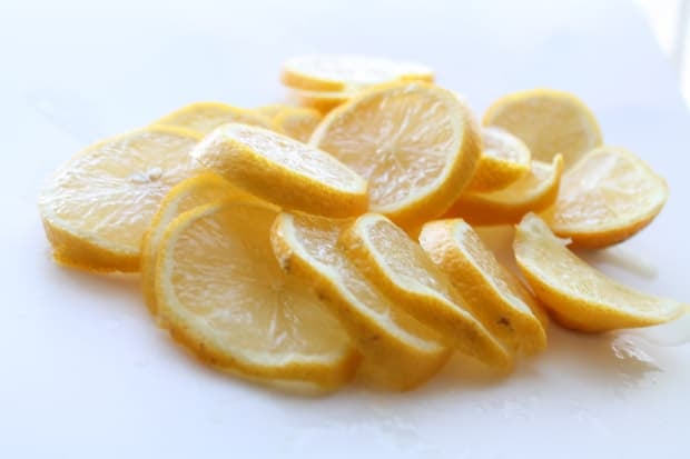 freshly sliced lemons on a cutting board