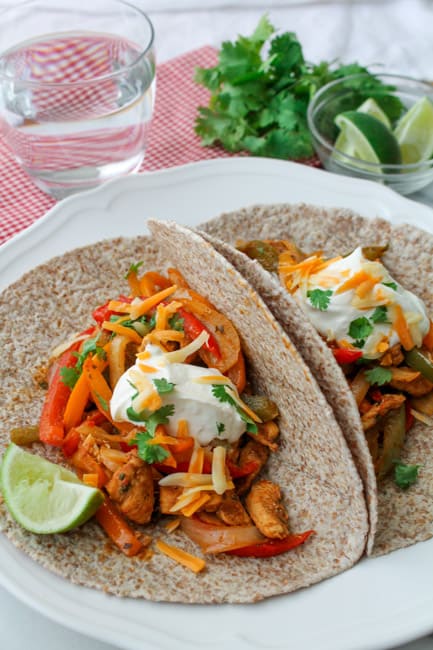 Baked Chicken Fajitas garnished with fresh lime