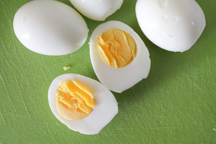hard boiled eggs sliced open revealing a creamy yellow yolk