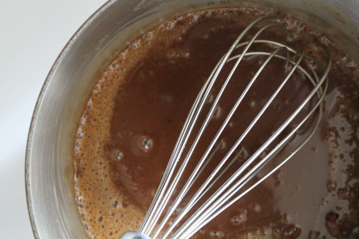 vegan caramel sauce being whisked in a pan