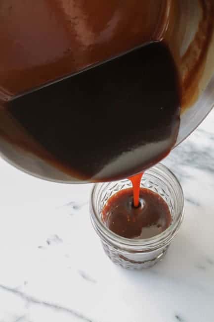 Vegan Salted Caramel Sauce being poured into a jar