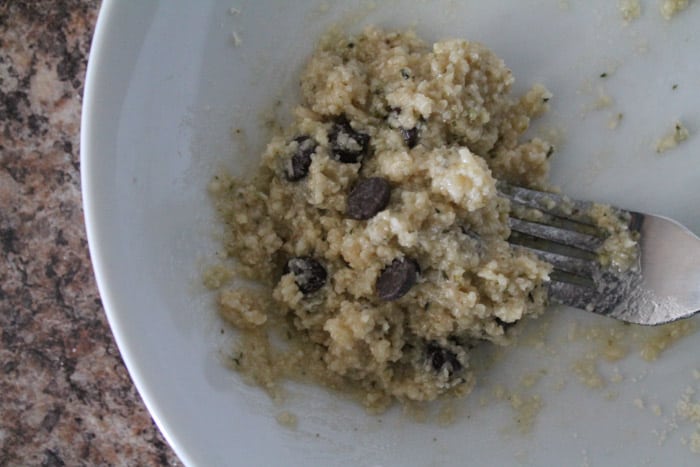 raw batter in a bowl being stirred with a fork