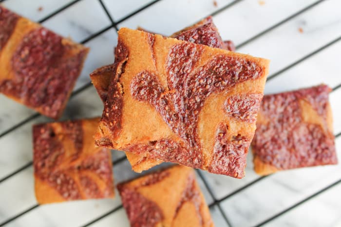 Peanut Butter & Jelly Cookie Bars on a wire baking rack