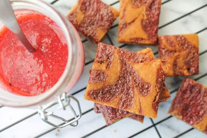 Peanut Butter & Jelly Cookie Bars on a wire baking rack