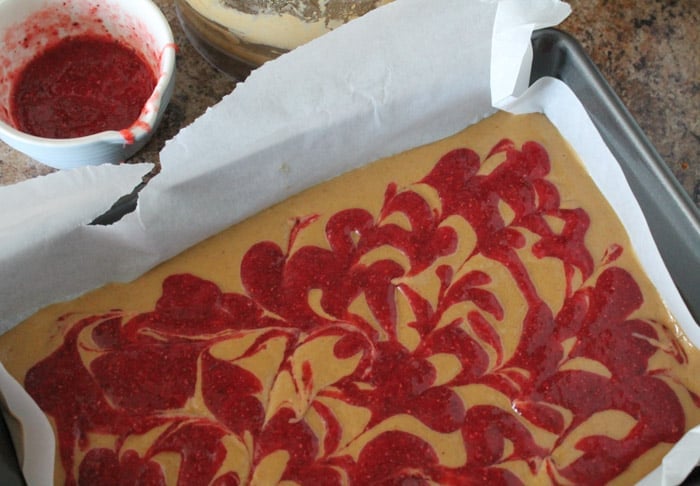 Chickpea Cookie Bars being swirled with jelly