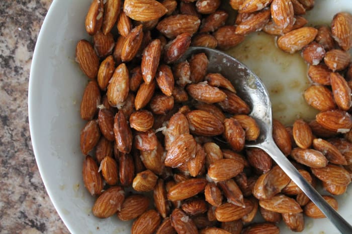 Almonds being stirred in a bowl