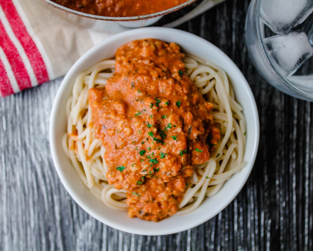 a bowl of pasta with walnut bolognese sauce.