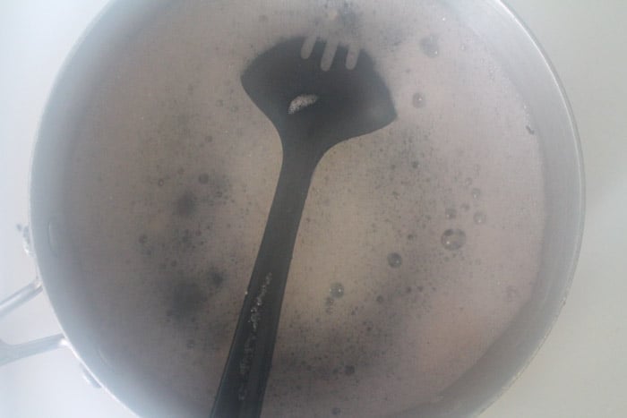a bubbling saucepan on a stove.