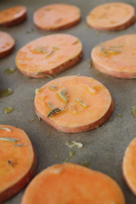 sweet potatoes sliced into rounds and laid on a baking sheet